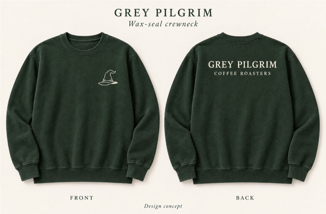 Wax-seal crewneck in forest green — small hat on the front, wordmark across the back